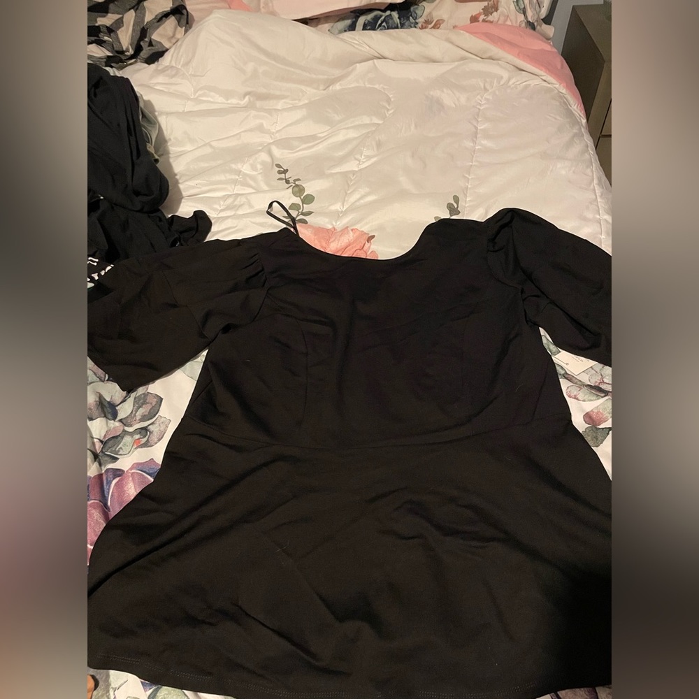 Eloquii size 22/24 black peplum top. “Poofy”-like sleeves.